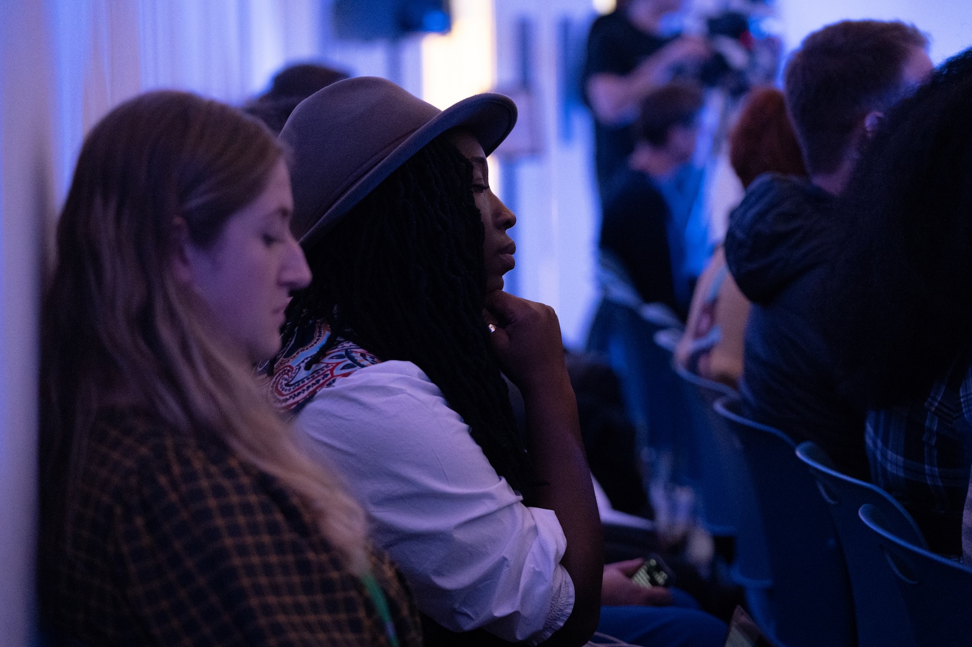 Two people with eyes closed listening to a spatial sound design of an imagined future