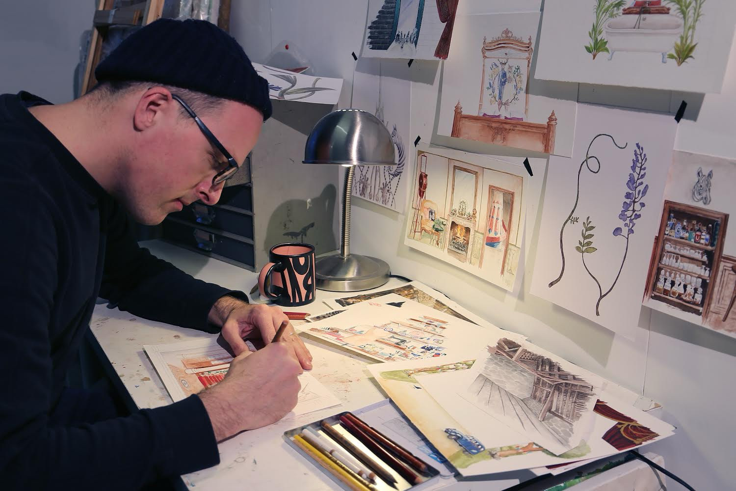 Picture of Sam Steer in his artists studio working on an illustration